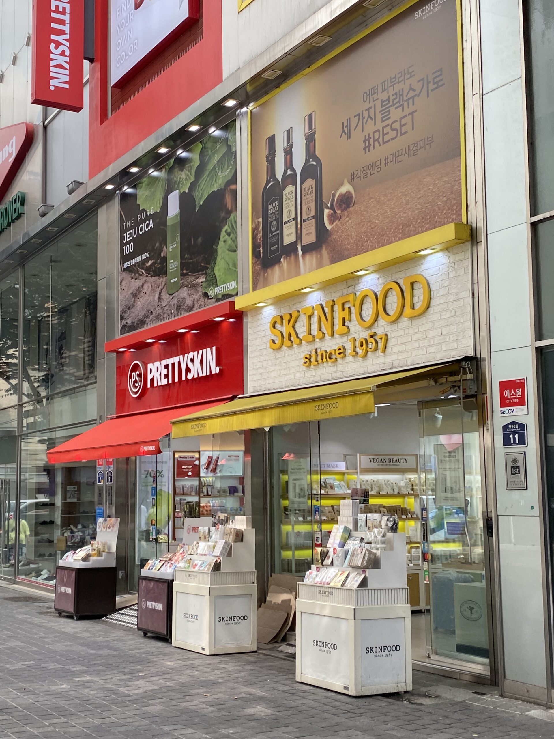 PRETTYSKIN and SKINFOOD skincare stores next to each other.